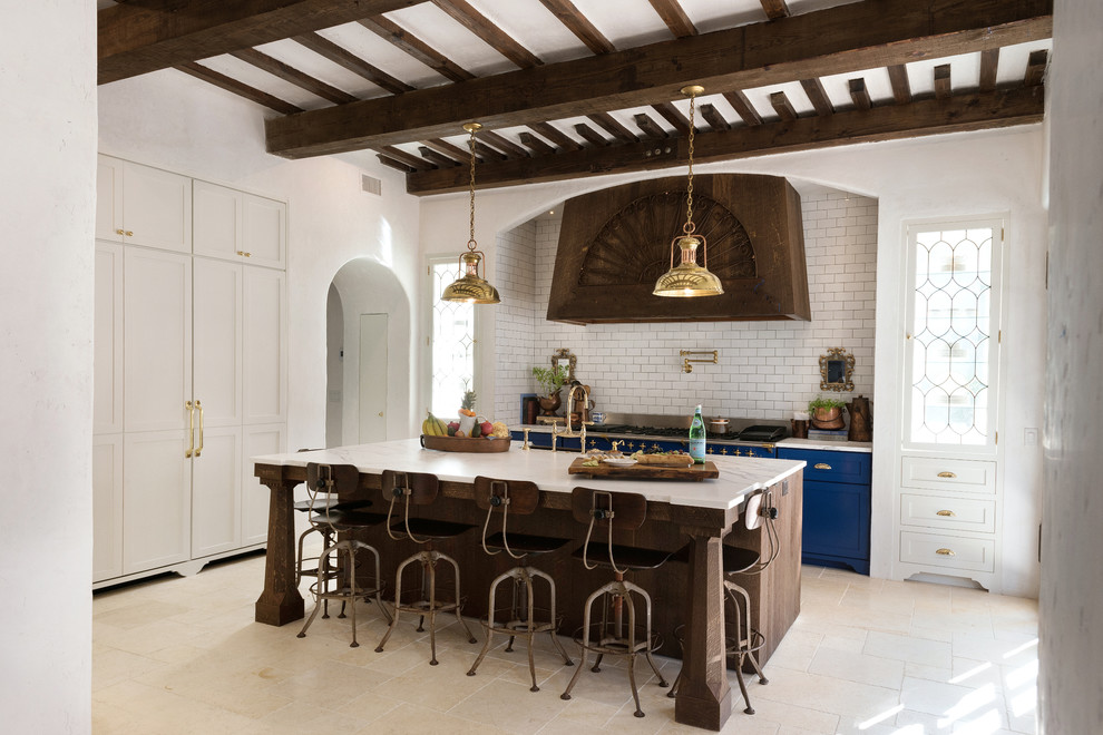 Design ideas for a mid-sized mediterranean galley separate kitchen in Jacksonville with shaker cabinets, white cabinets, marble benchtops, white splashback, coloured appliances, limestone floors, with island and subway tile splashback.