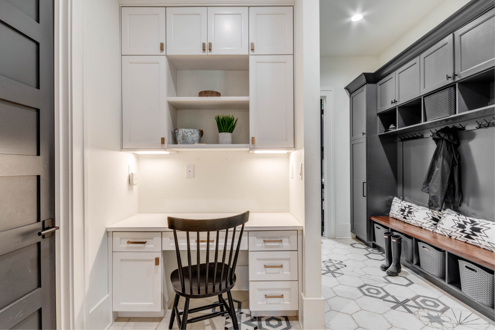 Inspiration for a large transitional mudroom in Atlanta with white walls, ceramic floors, a black front door, white floor and decorative wall panelling.