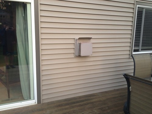 I have a fireplace in my living room that vents directly out to my back deck. It is an eyesore and has sharp edges. Looking for ways to hide or decorate. See photo. Ideas?