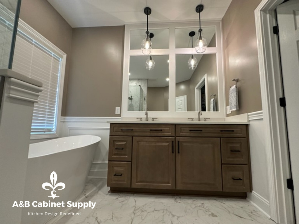 Example of a mid-sized transitional master cement tile floor, multicolored floor and double-sink freestanding bathtub design with raised-panel cabinets, medium tone wood cabinets, beige walls, an undermount sink, quartz countertops, white countertops and a built-in vanity