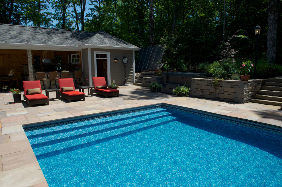Inspiration for a large traditional backyard rectangular pool in Other with brick pavers and a hot tub.