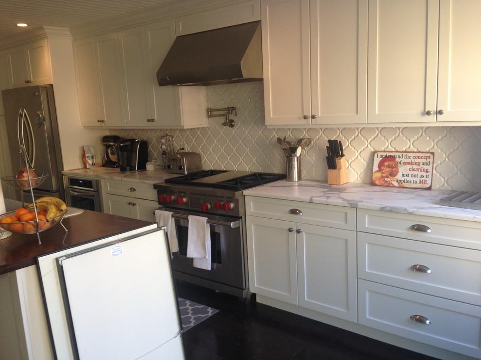 Large transitional galley dark wood floor eat-in kitchen photo in Baltimore with a farmhouse sink, shaker cabinets, white cabinets, wood countertops, white backsplash, ceramic backsplash, stainless steel appliances and an island