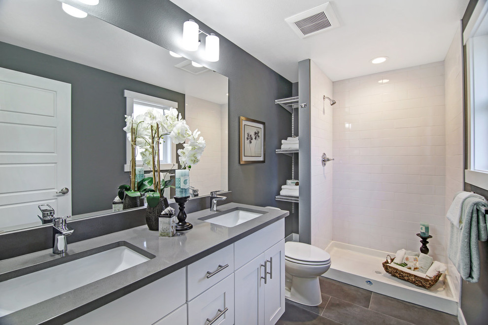 Inspiration for a mid-sized transitional master white tile and ceramic tile porcelain tile and gray floor alcove bathtub remodel in Seattle with shaker cabinets, a two-piece toilet, gray walls, an undermount sink, quartz countertops, gray countertops and white cabinets
