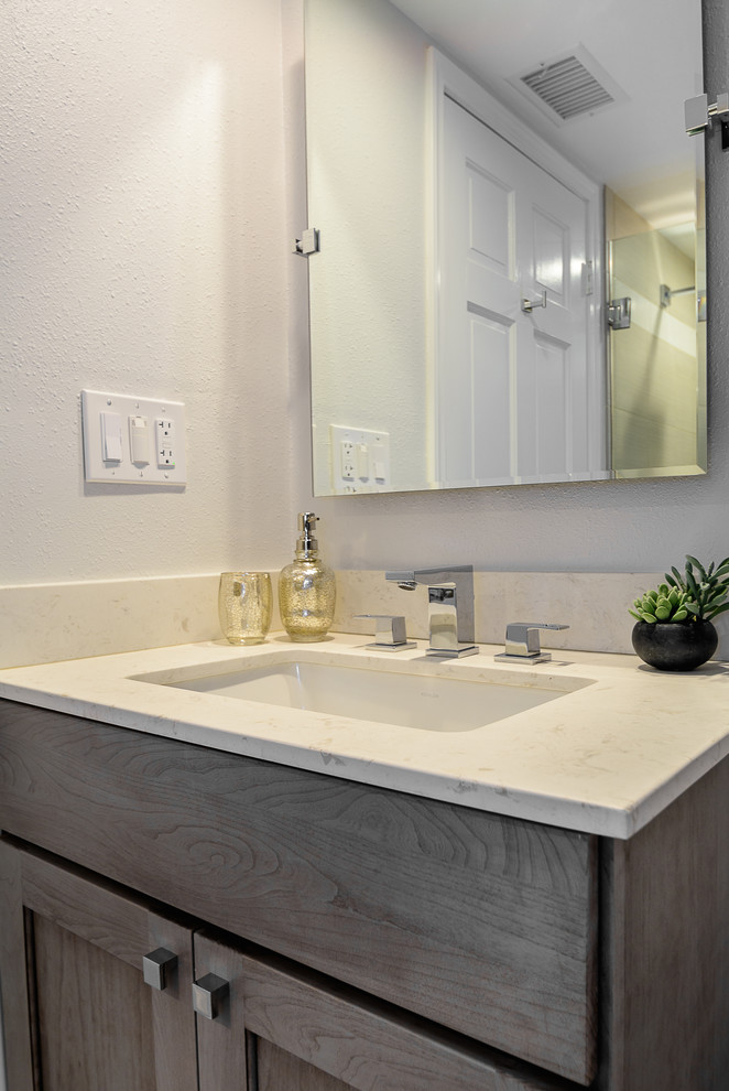 Design ideas for a mid-sized modern bathroom in Los Angeles with shaker cabinets, light wood cabinets, onyx benchtops, white walls and an undermount sink.
