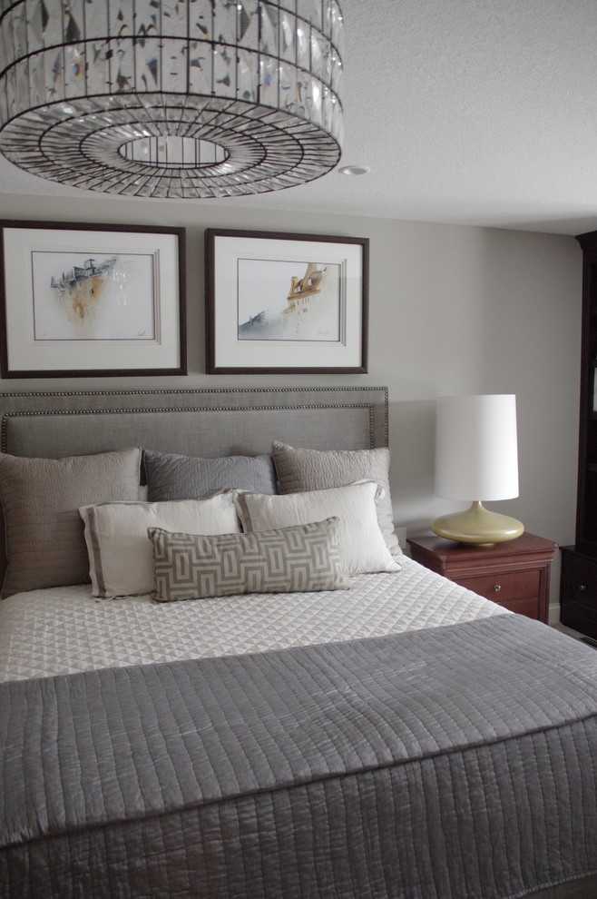 This is an example of a mid-sized transitional master bedroom in Other with grey walls, carpet and beige floor.