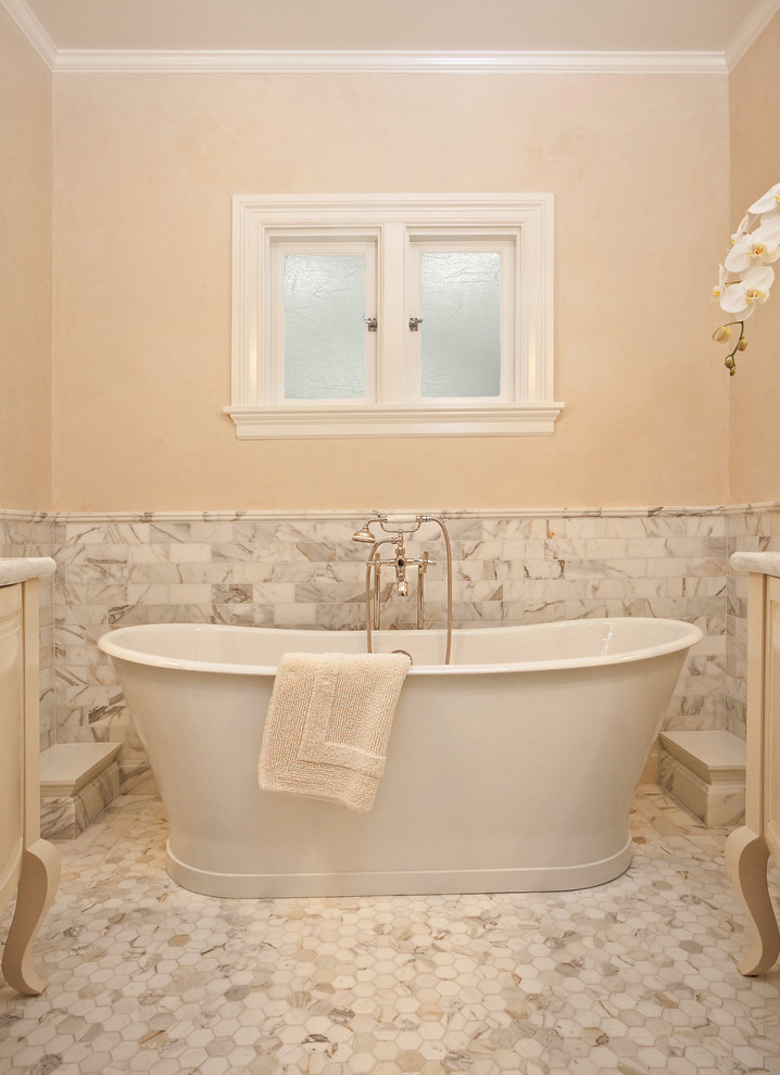 Inspiration for a small traditional master bathroom in Portland with a freestanding tub, mosaic tile, white cabinets, mosaic tile floors, marble benchtops, an undermount sink, beige walls and white tile.