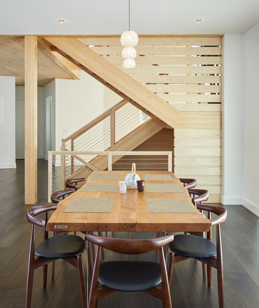 Contemporary dining room in Portland Maine with white walls, dark hardwood floors and brown floor.