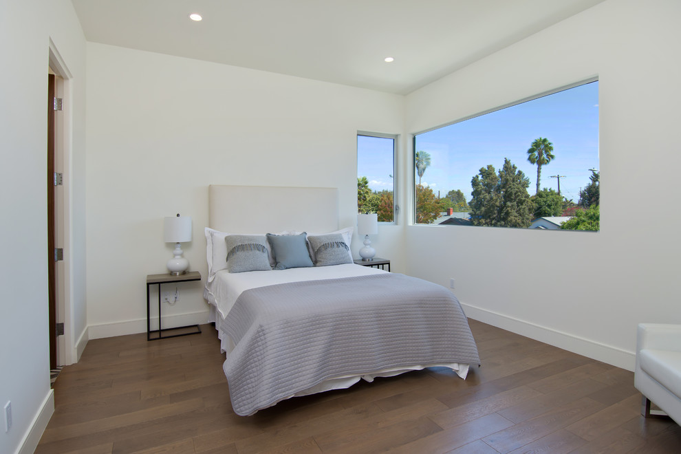 Contemporary bedroom in Los Angeles with medium hardwood floors.