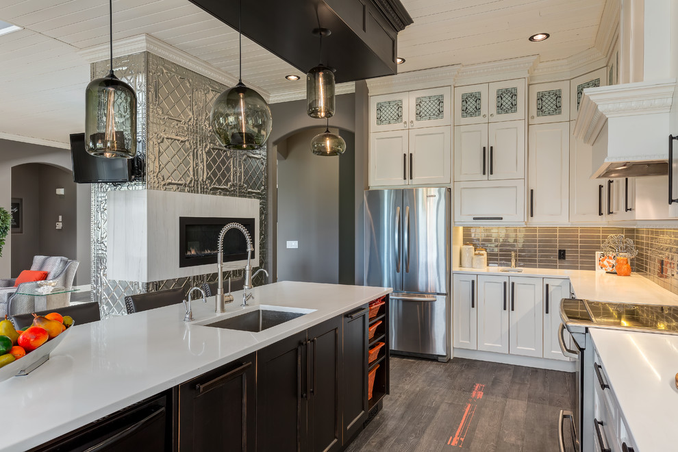 Transitional l-shaped porcelain tile open concept kitchen photo in Calgary with an undermount sink, recessed-panel cabinets, white cabinets, quartzite countertops, gray backsplash, ceramic backsplash, stainless steel appliances and an island