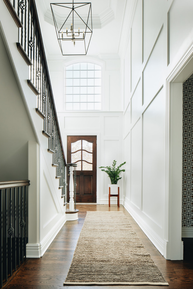 Mid-sized transitional dark wood floor and brown floor foyer photo in Chicago with white walls and a dark wood front door