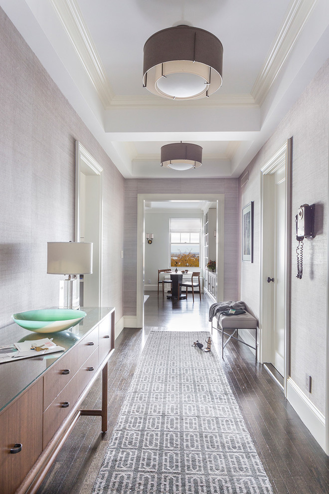 This is an example of a transitional hallway in New York with purple walls and medium hardwood floors.