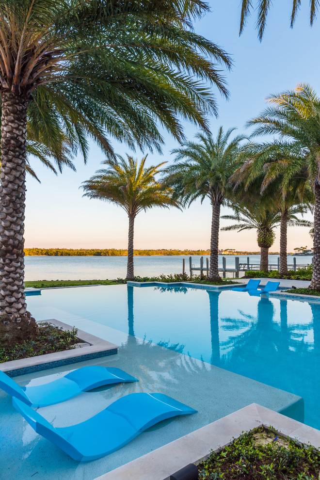 Photo of a mediterranean backyard infinity pool in Miami.