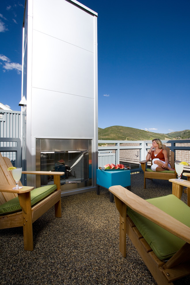 Inspiration for a mid-sized industrial rooftop deck in Salt Lake City with a fire feature and no cover.