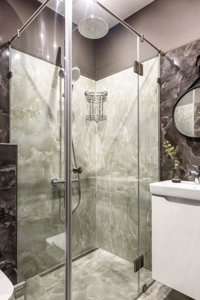 Photo of a mid-sized contemporary bathroom in Other with flat-panel cabinets, white cabinets, a corner shower, a hinged shower door, an enclosed toilet and a floating vanity.