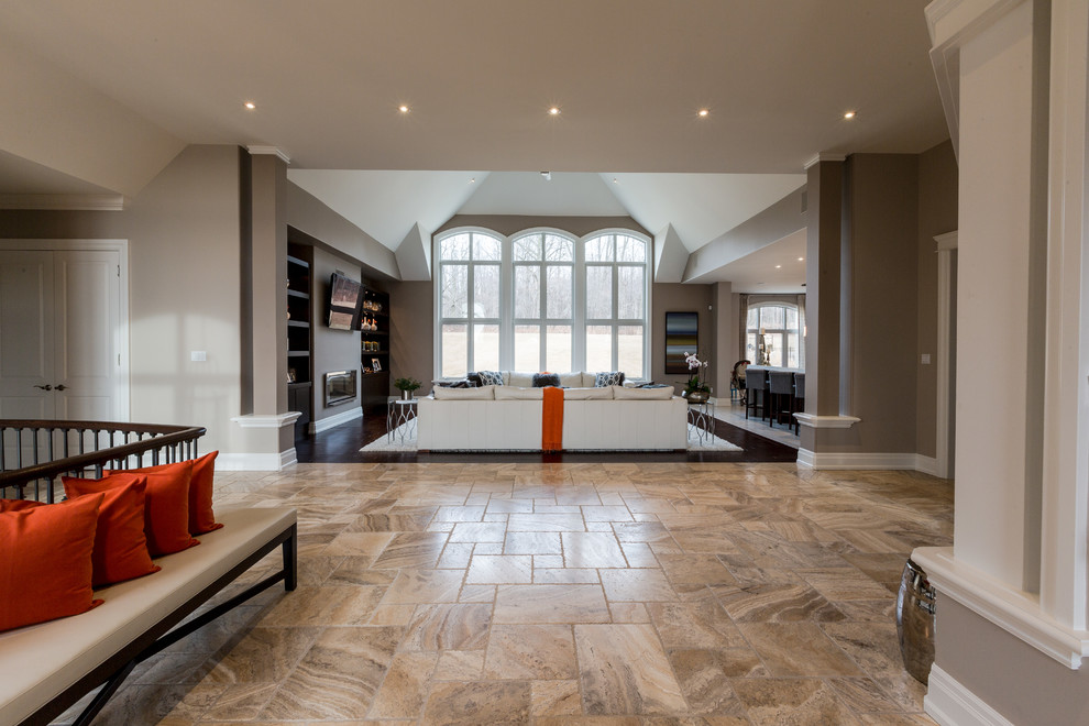 Inspiration for a large transitional foyer in Toronto with beige walls, travertine floors and beige floor.