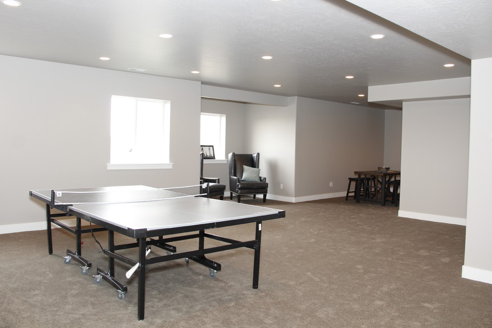This is an example of a traditional basement in Salt Lake City with grey walls and carpet.
