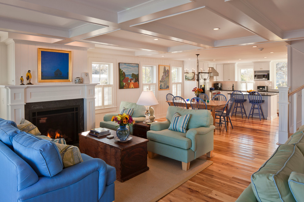 Large beach style formal open concept living room in Boston with white walls, medium hardwood floors, a standard fireplace, a stone fireplace surround, no tv and brown floor.
