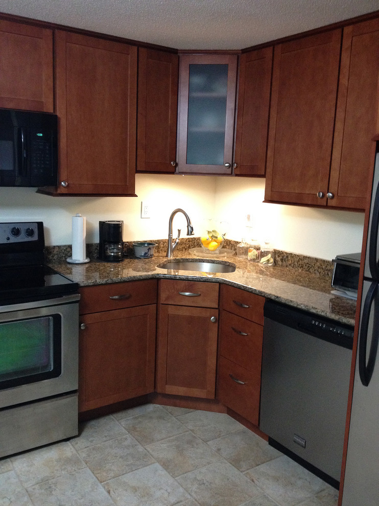 Small transitional l-shaped linoleum floor eat-in kitchen photo in Boston with an undermount sink, recessed-panel cabinets, medium tone wood cabinets, granite countertops, stainless steel appliances and no island