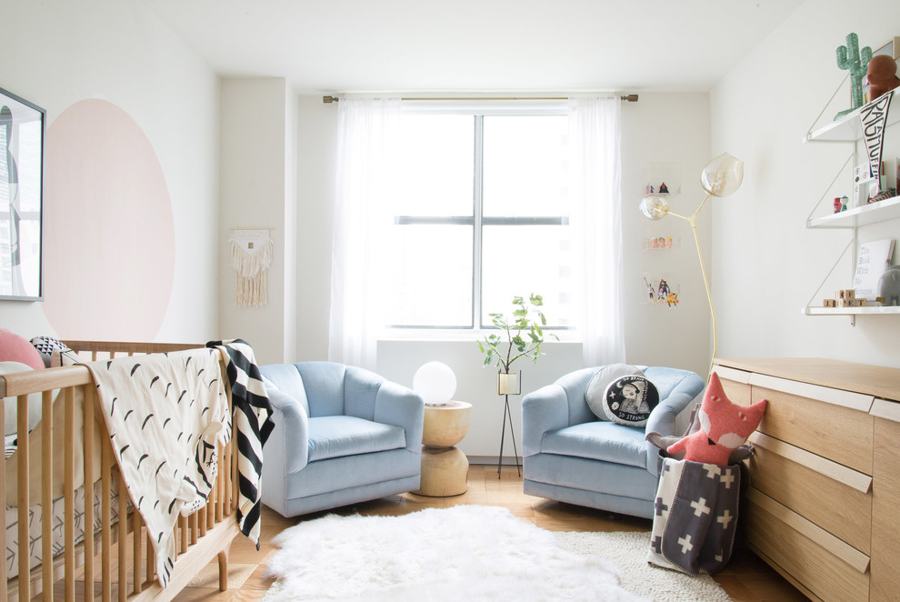 Photo of a transitional gender-neutral nursery in Other with white walls.