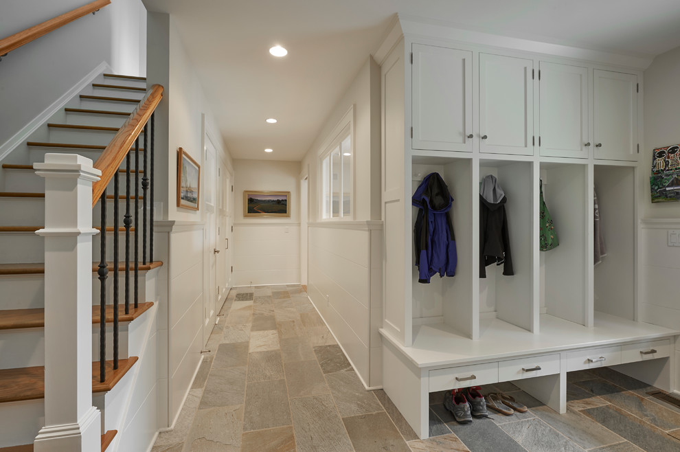 Mid-sized arts and crafts mudroom in New York with white walls and granite floors.