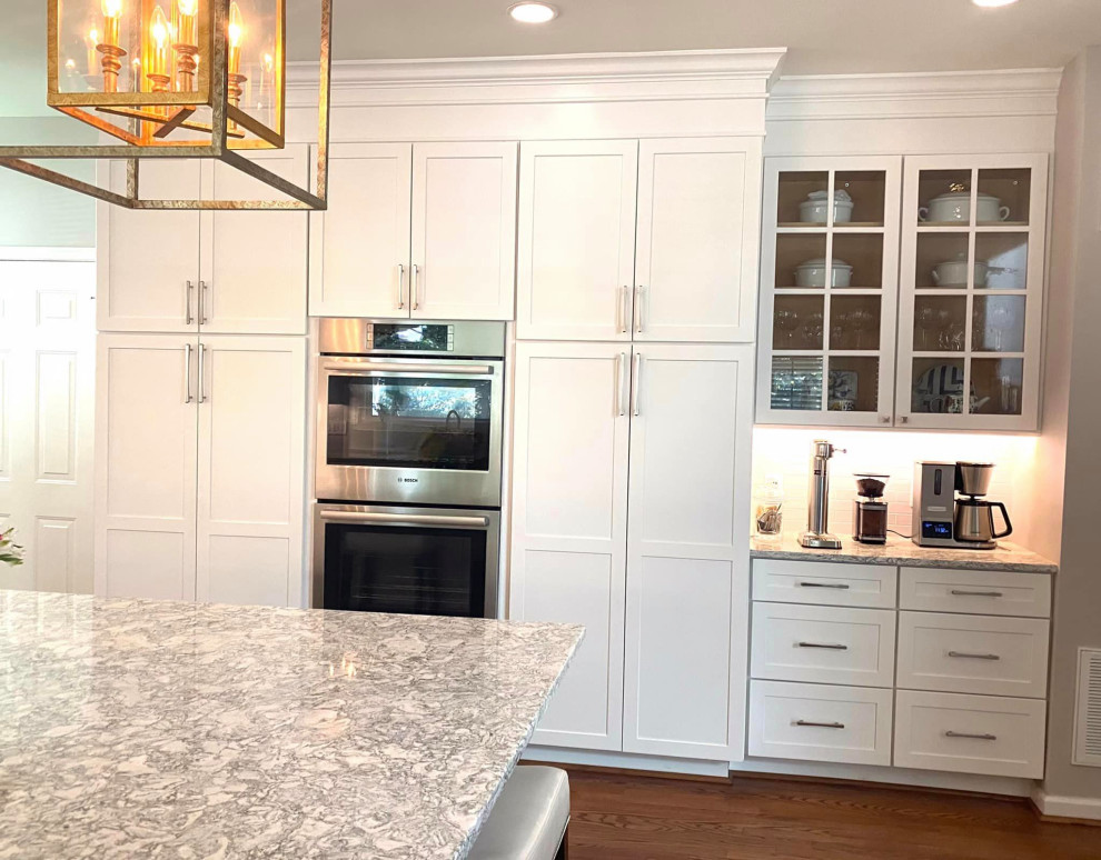Inspiration for a large contemporary u-shaped painted wood floor and brown floor eat-in kitchen remodel in DC Metro with a double-bowl sink, shaker cabinets, yellow cabinets, granite countertops, white backsplash, subway tile backsplash, stainless steel appliances, an island and gray countertops