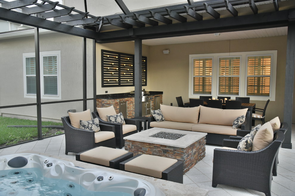 Screened area with sunken spa, fire pit and outdoor kitchen. Tropical