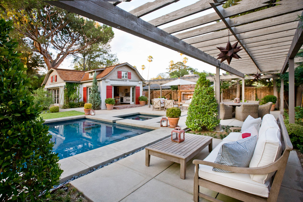 Design ideas for a country backyard patio in Los Angeles with concrete slab and a pergola.