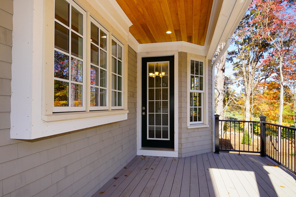 Deck - large transitional backyard deck idea in Boston with a roof extension