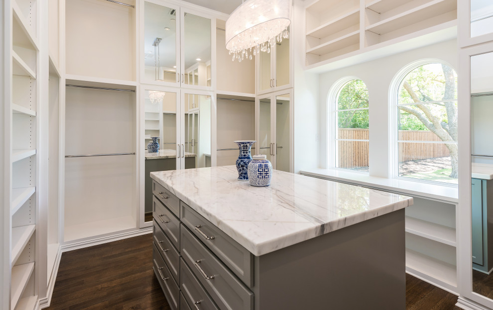Inspiration for a large mediterranean women's walk-in wardrobe in Dallas with shaker cabinets, white cabinets, medium hardwood floors and brown floor.