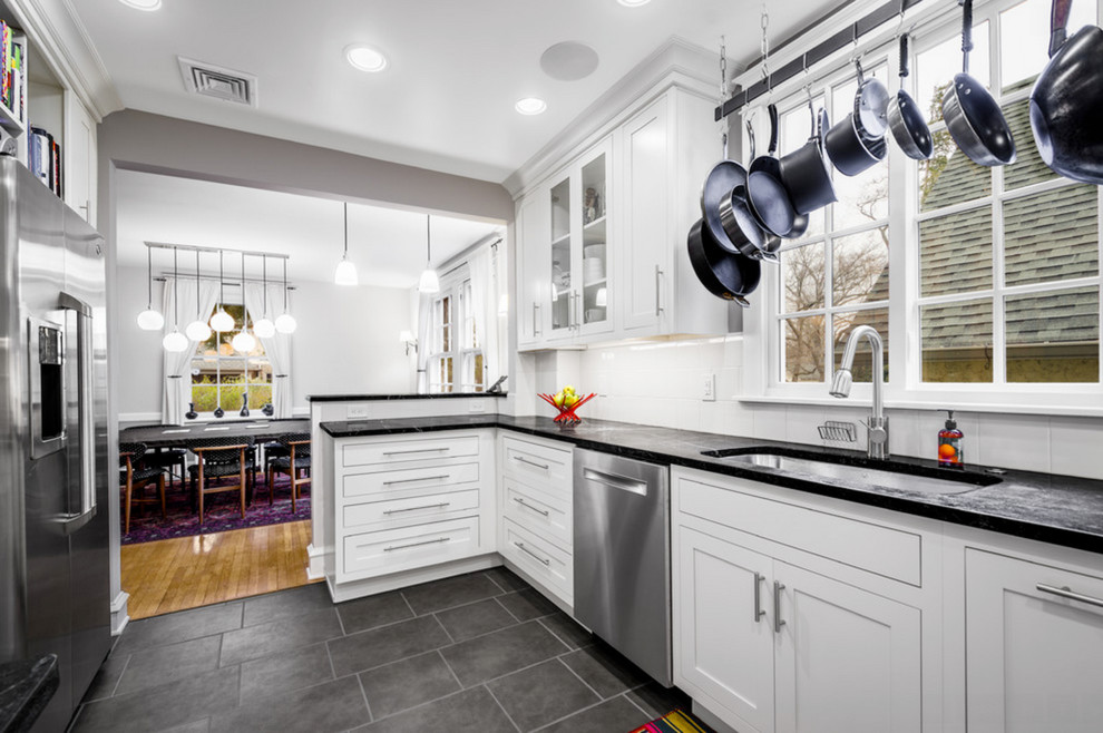 Eat-in kitchen - transitional ceramic tile eat-in kitchen idea with an undermount sink, beaded inset cabinets, white cabinets, white backsplash, ceramic backsplash, stainless steel appliances and an island