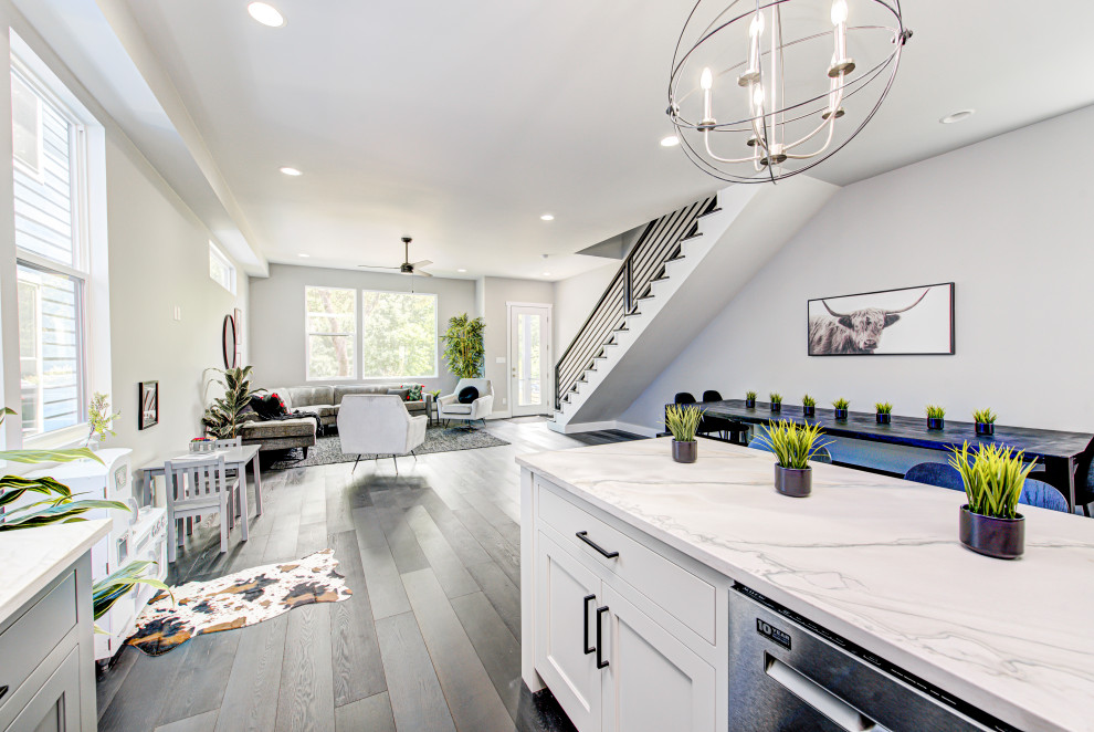 Eat-in kitchen - mid-sized transitional l-shaped light wood floor and gray floor eat-in kitchen idea in Indianapolis with flat-panel cabinets, gray cabinets, marble countertops, multicolored backsplash, ceramic backsplash, an island and white countertops