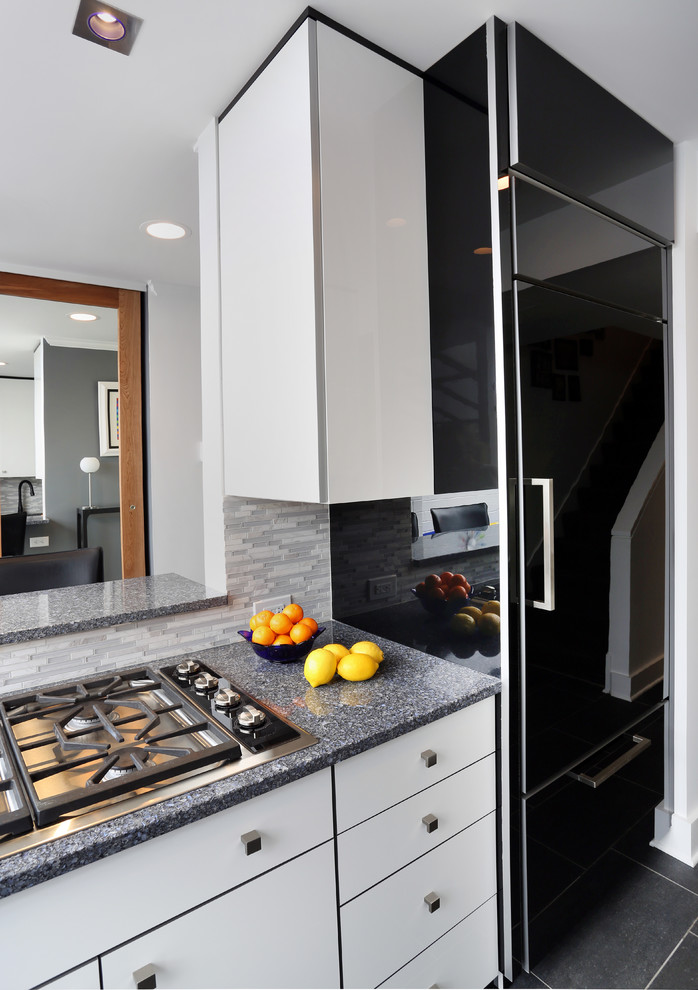 Design ideas for a mid-sized contemporary galley eat-in kitchen in Chicago with flat-panel cabinets, white cabinets, grey splashback, no island, black appliances, porcelain floors, quartz benchtops and glass tile splashback.