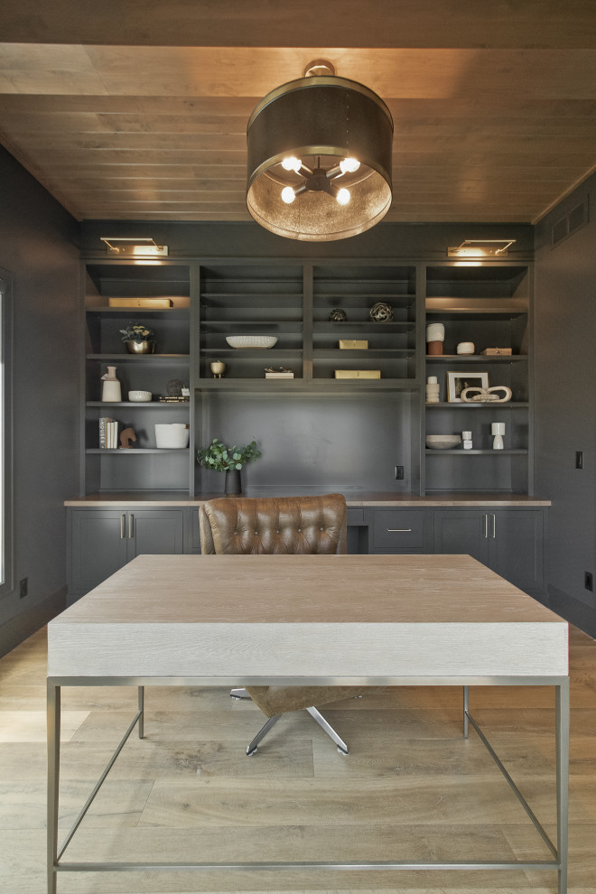 Foto de despacho tradicional renovado con paredes negras, suelo de madera en tonos medios, suelo marrón y madera