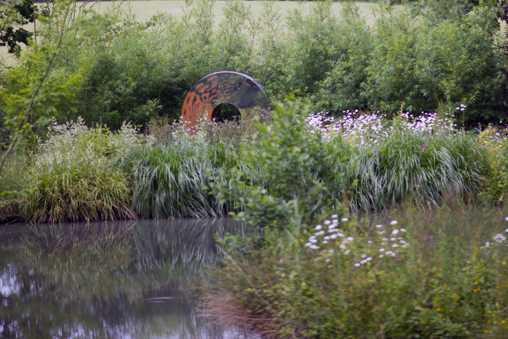 Inspiration for an expansive vintage back garden in Kent with a water feature.