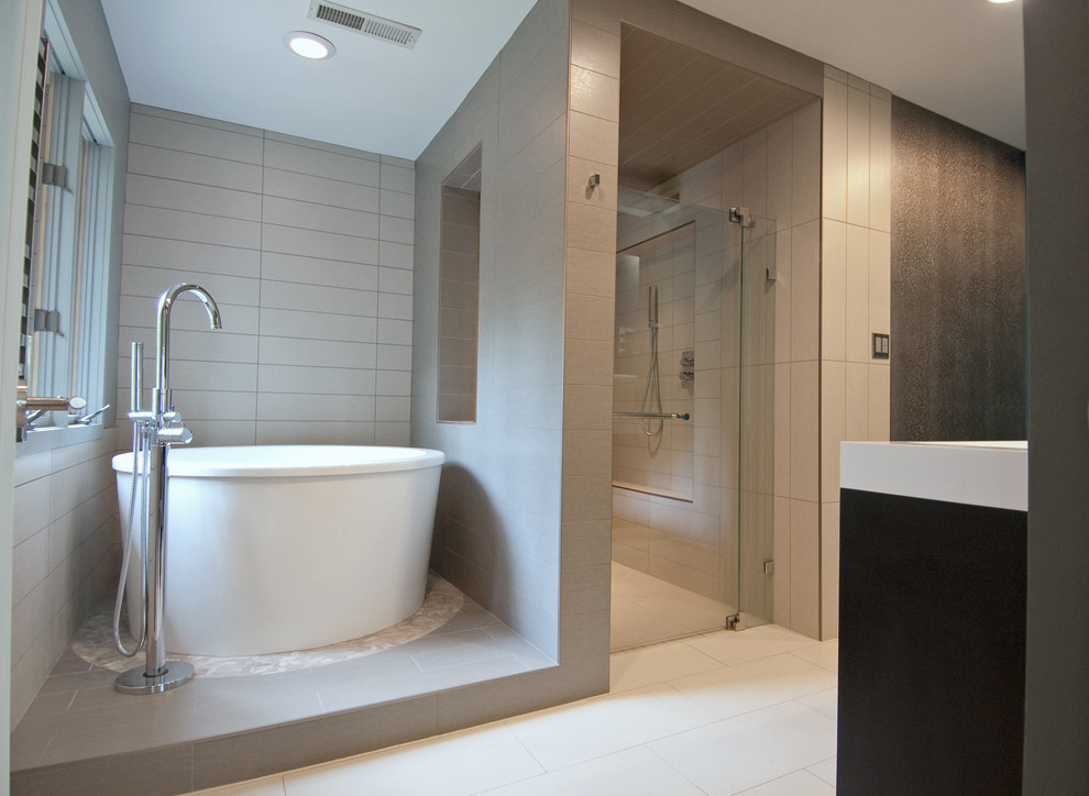 Inspiration for a small modern master bathroom in Charlotte with a vessel sink, dark wood cabinets, a japanese tub, a curbless shower, a one-piece toilet, gray tile, ceramic tile, grey walls and porcelain floors.