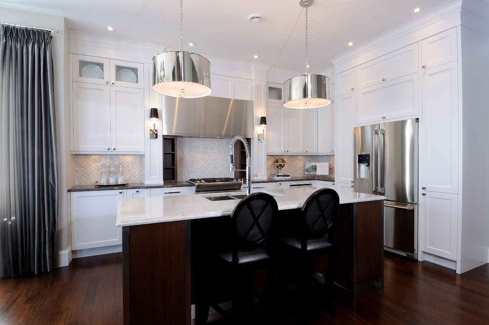 Eat-in kitchen - mid-sized transitional l-shaped dark wood floor eat-in kitchen idea in Calgary with an undermount sink, recessed-panel cabinets, white cabinets, quartz countertops, multicolored backsplash, mosaic tile backsplash, stainless steel appliances and an island