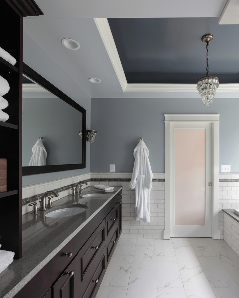 Corner shower - mid-sized transitional master white tile and subway tile porcelain tile corner shower idea in DC Metro with an undermount sink, recessed-panel cabinets, dark wood cabinets, solid surface countertops, an undermount tub, a two-piece toilet and blue walls