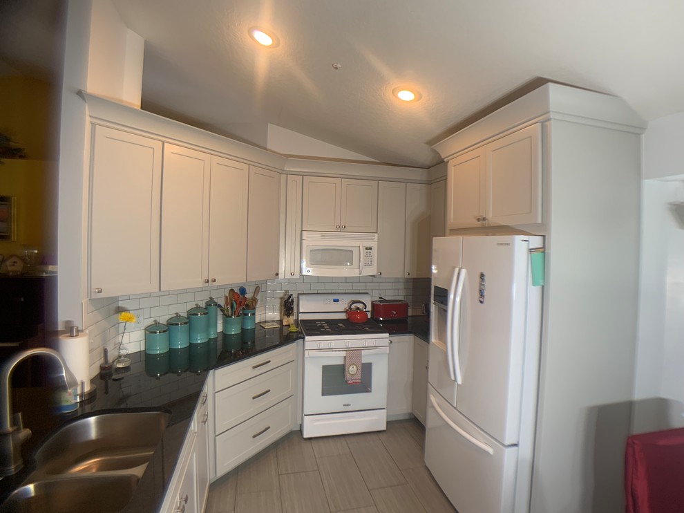 Small transitional u-shaped ceramic tile eat-in kitchen photo in Orlando with an undermount sink, shaker cabinets, gray cabinets, granite countertops, subway tile backsplash and no island
