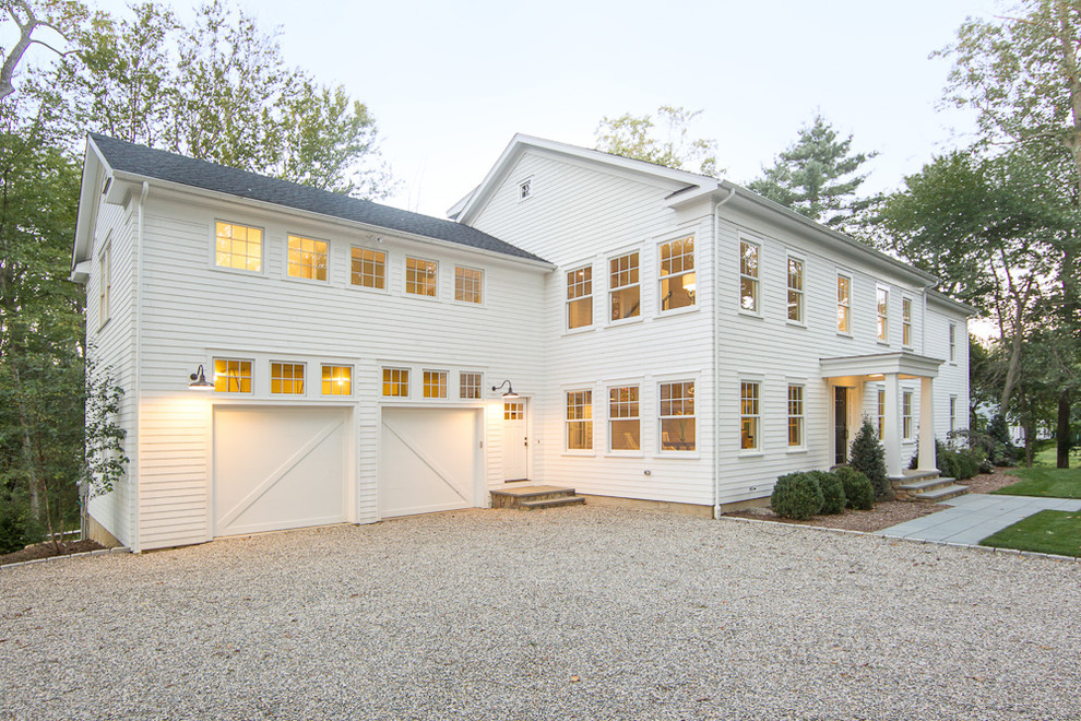 Inspiration for a country two-storey white exterior in New York with wood siding.