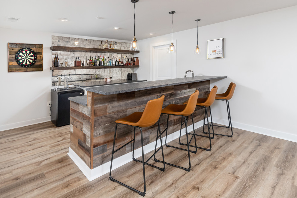 This is an example of a mid-sized contemporary home bar in Philadelphia with brown floor.