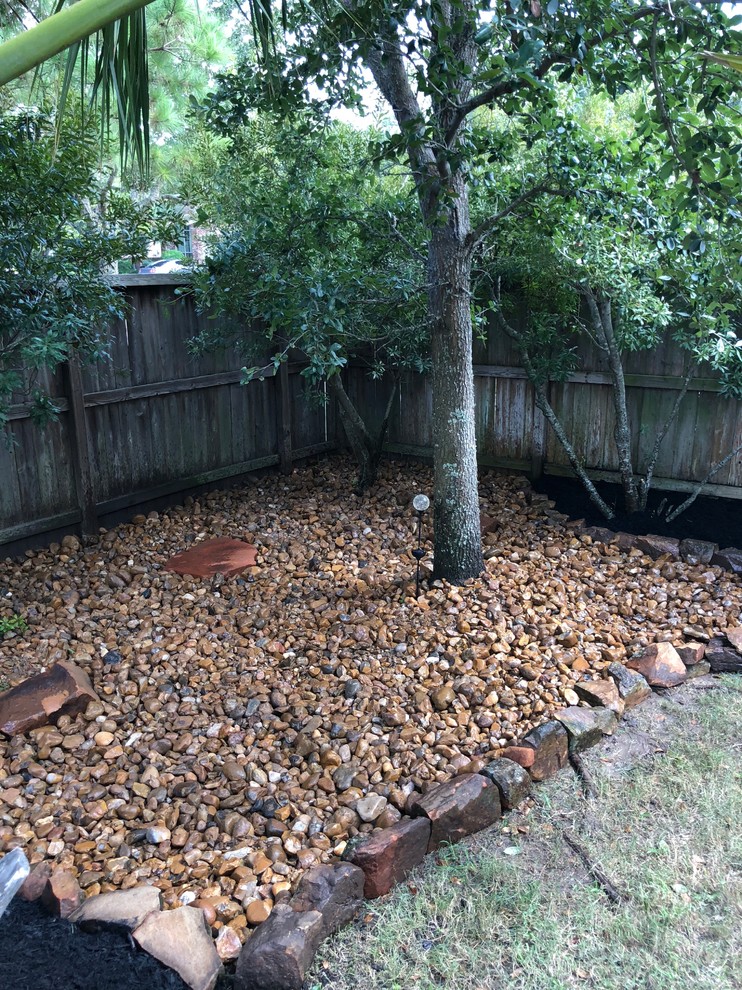 Photo of a rustic partial sun backyard landscaping in Houston.
