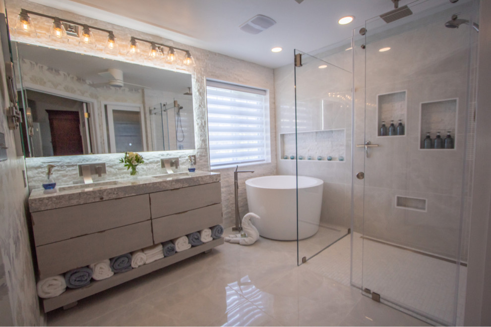 Photo of a modern master bathroom in Baltimore with flat-panel cabinets, grey cabinets, a japanese tub, gray tile, porcelain tile, engineered quartz benchtops, grey benchtops, a double vanity and a floating vanity.
