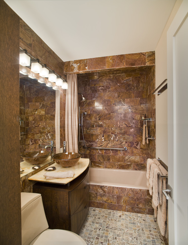 Inspiration for a contemporary bathroom in New York with stone tile and a vessel sink.