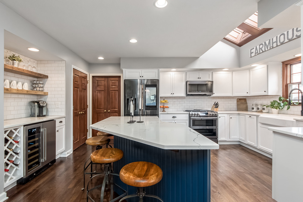 Inspiration for a large transitional u-shaped eat-in kitchen remodel in Columbus with shaker cabinets, quartz countertops, white backsplash and an island