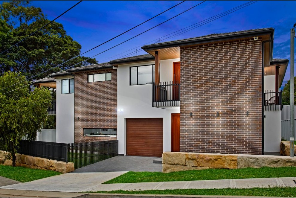 This is an example of an industrial two-storey brick grey duplex exterior in Sydney with a tile roof.
