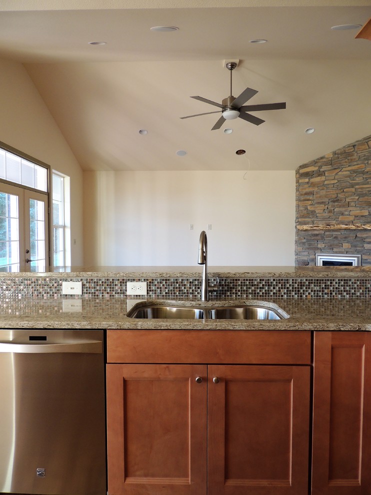 Inspiration for a large transitional u-shaped light wood floor eat-in kitchen remodel in Seattle with recessed-panel cabinets, medium tone wood cabinets, multicolored backsplash, mosaic tile backsplash, stainless steel appliances, an island and quartz countertops
