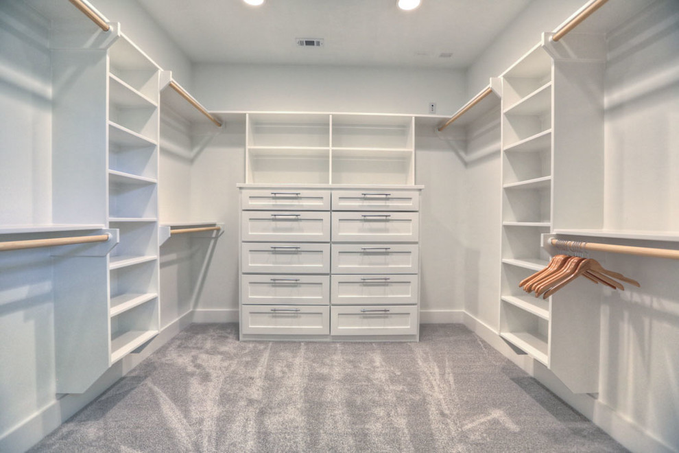 Inspiration for a mid-sized contemporary gender-neutral walk-in wardrobe in Houston with white cabinets, carpet and shaker cabinets.