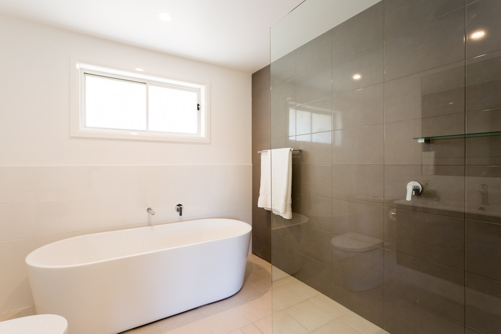 Design ideas for a mid-sized contemporary master bathroom in Other with a freestanding tub, an open shower, a two-piece toilet, ceramic floors, an integrated sink and an open shower.
