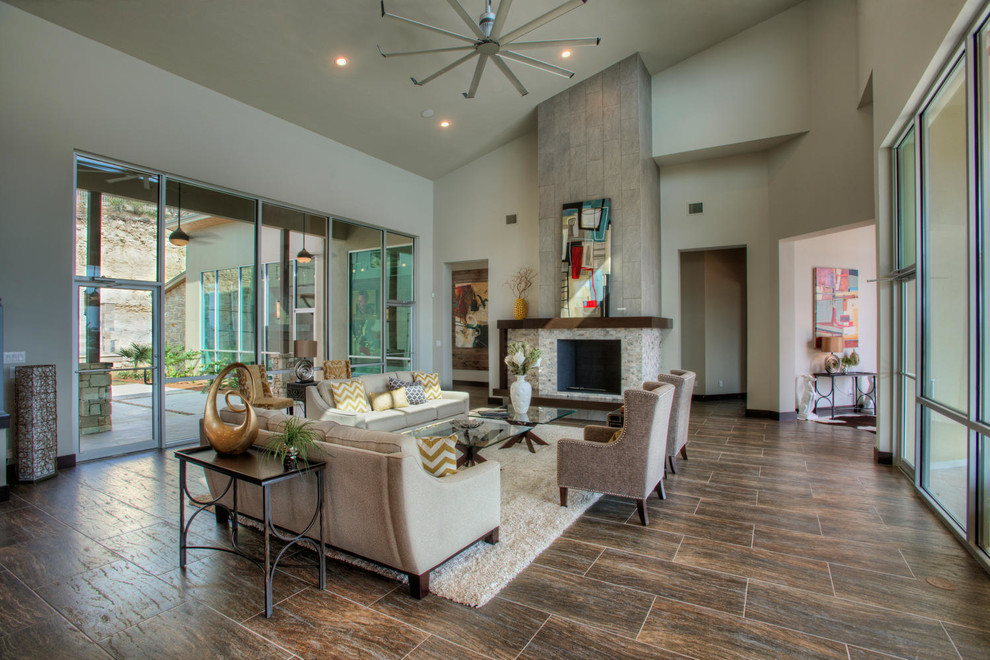This is an example of a large contemporary open concept living room in Austin with white walls, a standard fireplace and a stone fireplace surround.