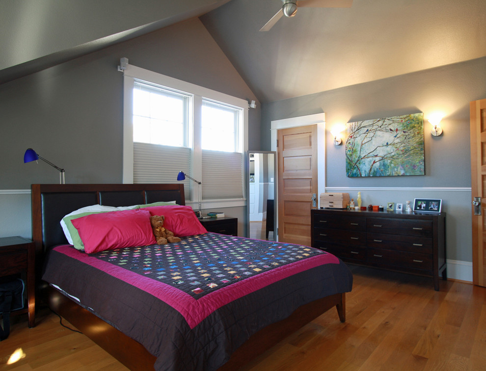 Design ideas for a large arts and crafts master bedroom in Portland with grey walls and medium hardwood floors.